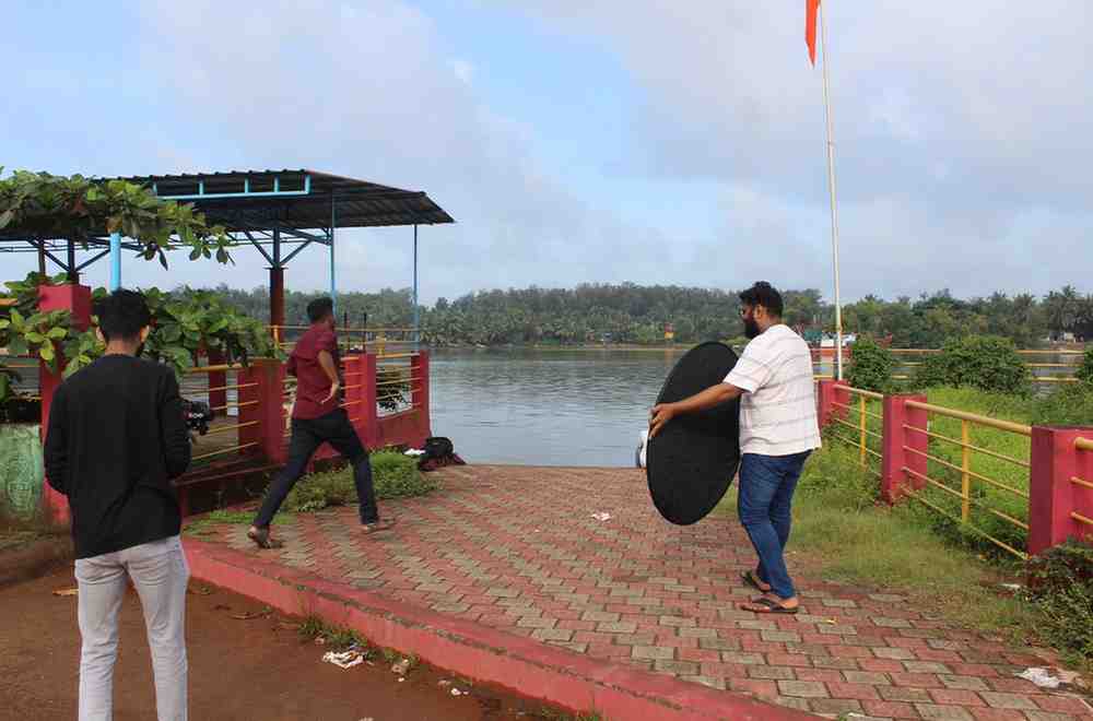 Director and crew watching a playback of a scene